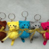 Four Crocheted Keychains With Cats On Them, One Has A Bow serapportantà Porte Clé Crochet Modèle Gratuit